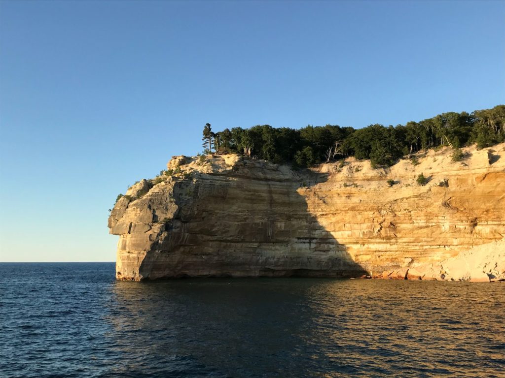 Photo of cliffs at Pictured Rocks National Lakeshore, late evening, from the water.