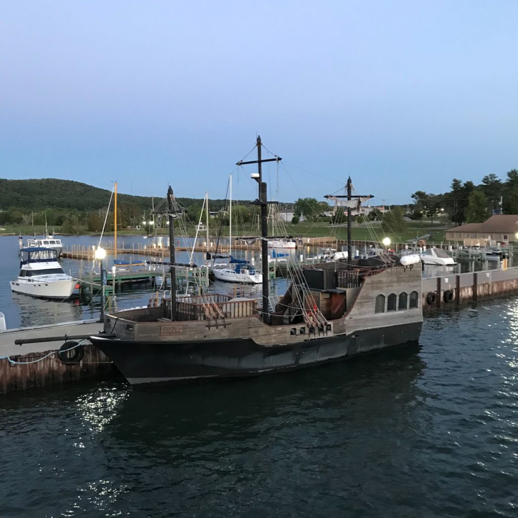 photo of fake "pirate ship" in Munising Harbor at dusk. 